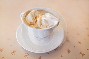 Ice cream in an espresso coffee called an affogato coffee in a white cup and saucer