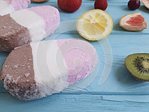 Ice cream fruits dessert on a blue wooden background, grapefruit, lemon, kiwi, pattern, strawberry