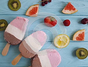 Ice cream fruits dessert flavor on a blue wooden background, grapefruit, lemon, kiwi, pattern, strawberry