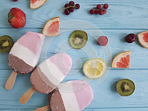 Ice cream fruits milk dessert flavor on a blue wooden background, grapefruit, lemon, kiwi, pattern, strawberry