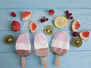 Ice cream fruits milk dessert natural flavor on a blue wooden background, grapefruit, lemon, kiwi, pattern, strawberry