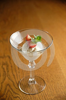 Ice cream in a glass martinique with mint leaf and strawberries