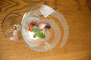 Ice cream in a glass martinique with mint leaf and strawberries