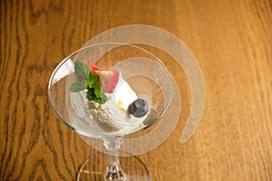 Ice cream in a glass martinique with mint leaf and strawberries