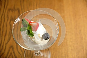 Ice cream in a glass martinique with mint leaf and strawberries