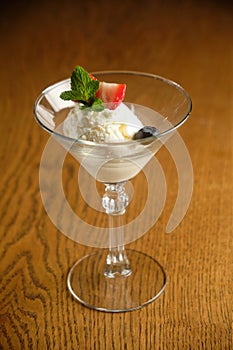 Ice cream in a glass martinique with mint leaf and strawberries