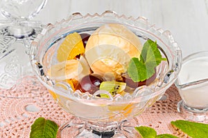 Ice cream with grapes and bananas in a glass bowl