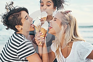 Ice cream makes the girls go wild. Cropped shot of three friends eating ice while out on the promenade.