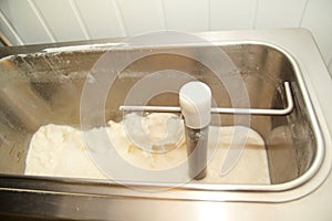 Ice cream making process at ice cream factory, milk and cooking mixing milk in pasteurization machine preparing basis.