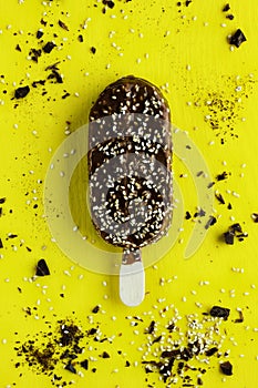Ice cream with nuts and dark chocolate isolated on yellow background