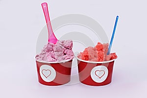 Ice cream in papier cups with heart symbol on white background.
