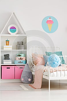 Ice cream poster on white wall above bed in scandi child`s bedro