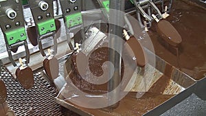 Ice cream production, chocolate coating process on ice cream, production line, dairy products.