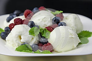 ice cream with raspberries, blueberries and mint leaves