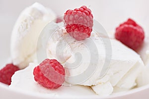 Ice cream with ripe fresh raspberries. Close-up