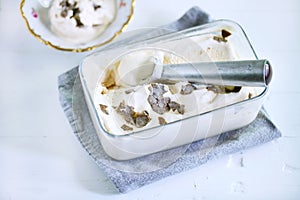 Ice cream scoop in ice box with salty caramel ice cream and truffles