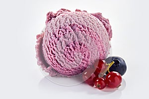 Ice cream scoop with redcurrant and blueberry