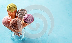 Ice cream scoops in cones with copy space on blue