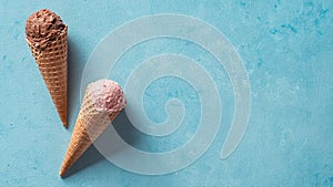 Ice cream scoops in cones with copy space on blue