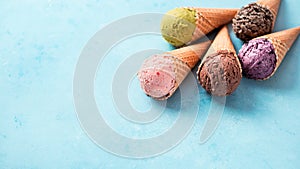 ice cream scoops in cones with copy space on blue