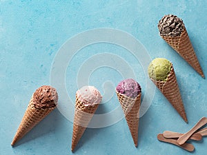 ice cream scoops in cones with copy space on blue