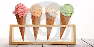 Ice cream scoops of different colors and flavours with berries, nuts and fruits decoration on white background