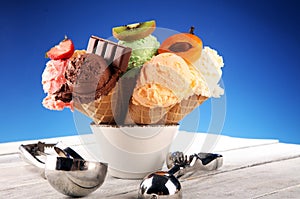 Ice cream scoops of different colors and flavours with berries, nuts and fruits decoration on white background