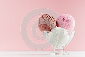 Ice cream scoops different flavor - strawberry, chocolate, creamy  in transparent glass ice-cream bowl in modern pink color.