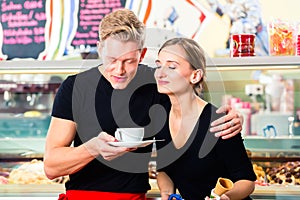 Ice cream seller and waiter working in cafe