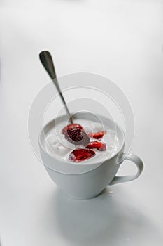 Ice cream with strawberries in a cup on the table