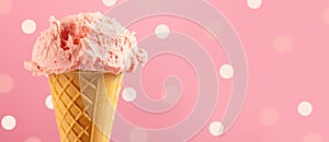 Ice cream. Strawberry or raspberry flavor icecream in waffle cone over pink polka dots background