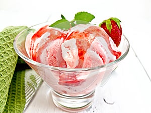 Ice cream strawberry with syrup in glass on light board