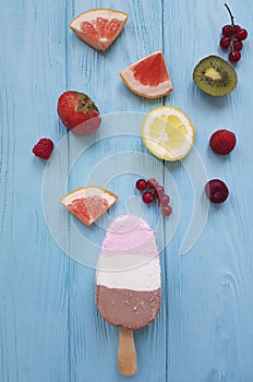 Ice cream summer milk dessert fresh cream flavor on a blue wooden background, grapefruit, lemon, kiwi, pattern, strawberry