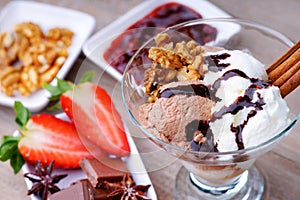 Ice cream sundae, chocolate, jam and sliced strawberry