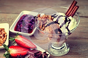 Ice cream sundae, chocolate, walnuts, sliced strawberry and jam
