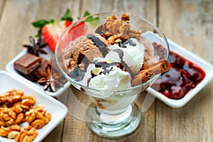 Ice cream sundae, chocolate, walnuts, sliced strawberry and jam