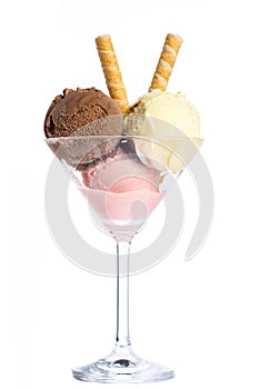 Ice cream: Three scoops of ice cream in red, yellow and brown in a martini glass