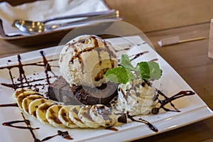 Ice cream vanila and chocolate souce banana dessert photo