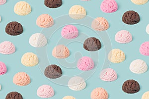 Ice cream various flavor scoops pattern on a pastel blue background.