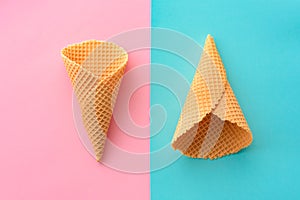 Ice cream waffle cones on pastel pink and blue background