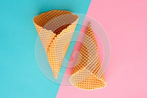 Ice cream waffle cones on pastel pink and blue background