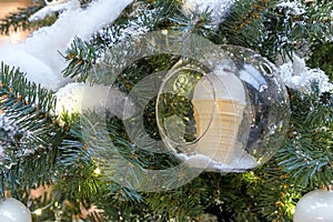 Ice cream in a waffle cup inside a transparent ball on Christmas tree. New Year concept