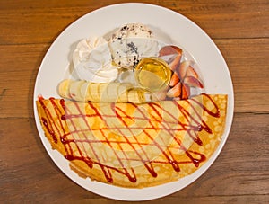 Ice creame crape with strawberry sauce and banana