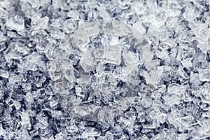 Ice crystals of frozen water on a dark surface