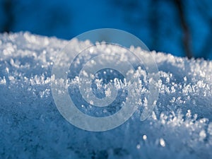 Ice crystals on snow with blue background