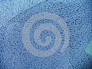 Ice crystals on the windshield of a car. Frost.