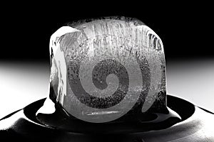 Ice cube on black background. Low key photo