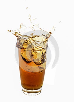 Ice cube droped in cola glass