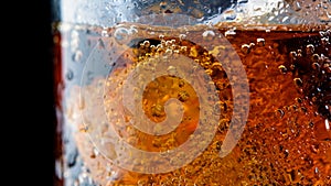 Ice cube in fizzy splashing water with soda