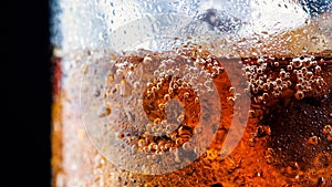 Ice cube in fizzy splashing water with soda